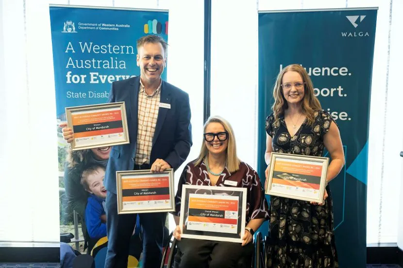 Three city of mandurah staff members accepting Mandurah's most accessible community award
